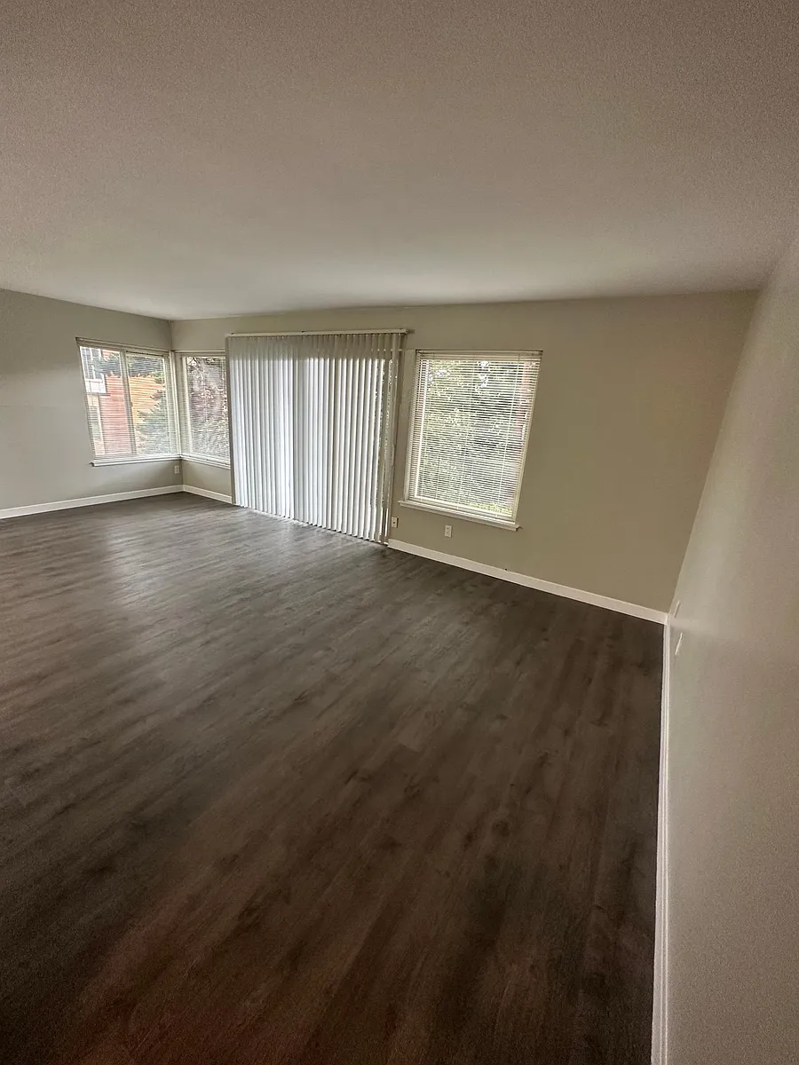 Large living room with balcony and dining room area. West facing balcony and windows and south facing windows in the living and dining area. - 2003 Franklin Ave E #202