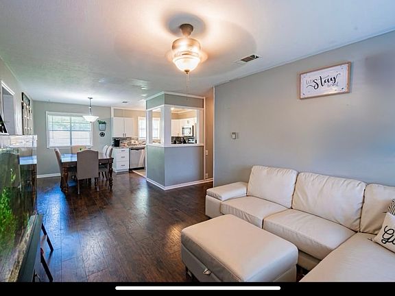 Entry to living room open to dining and kitchen