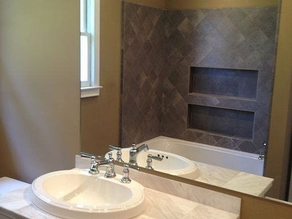Custom bathroom features including marble top, tiled shower,