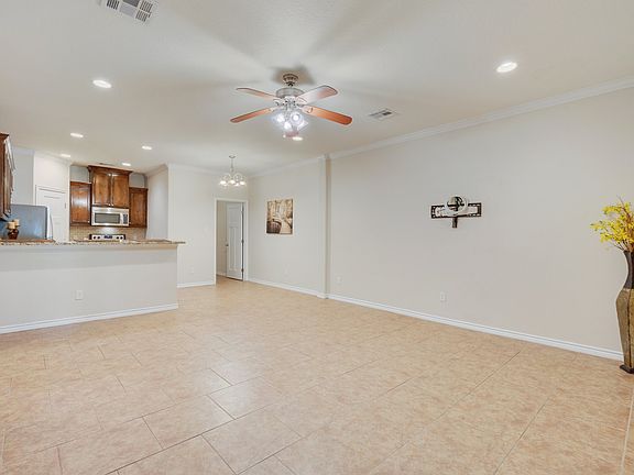 The living and kitchen areas are all tiled and include TV mounts. Each room has a ceiling fan.