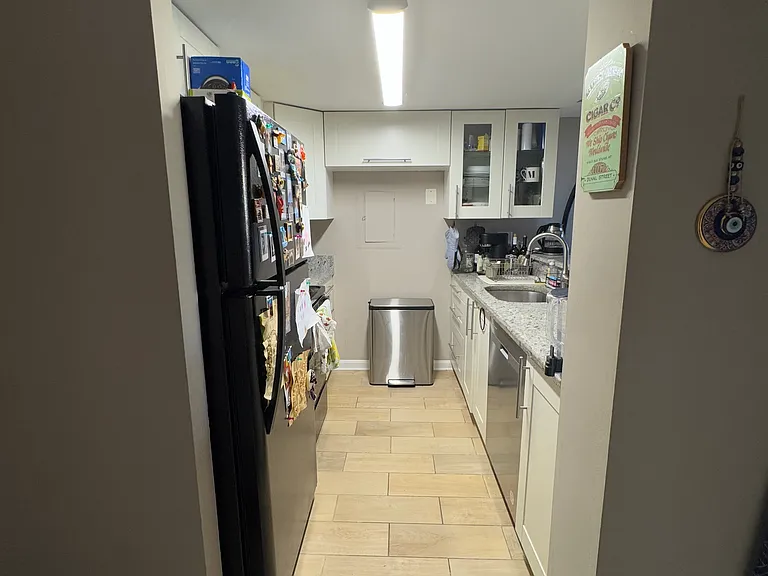 Galley kitchen renovated recently. Dishwasher is less than a year old. Good amount of storage. 

Picture taken from the door to the bathroom. Front door is on the left. Living room/dining room is on the right.
