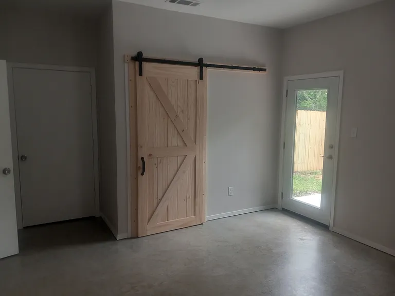 Large Bedroom with rear entry door
