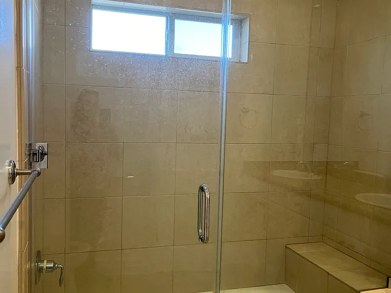 DESIGNER TILE W/ DECORATIVE BENCH AND GLASS DOOR
