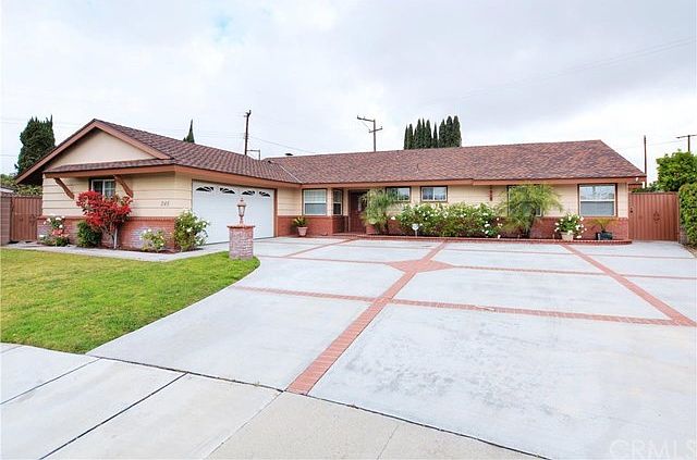Welcome Home! The carriage light post, ample landscaping and ribboned driveway all add a nice touch,