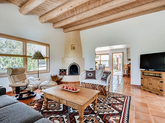 Great room with wood burning Kiva fireplace ... looking southeast to the dining area
