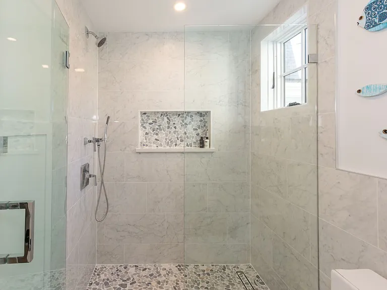 Downstairs bathroom. Overhead and hand held shower heads. Beach pebble shower