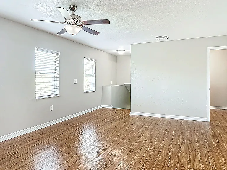 Enjoy a bright and spacious living area with wood-style flooring and ample natural light.