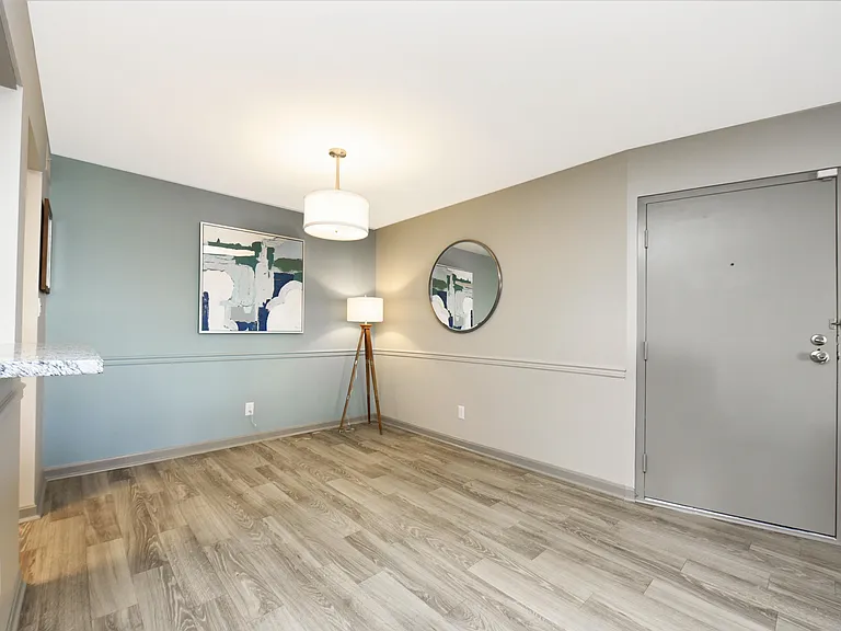 Dining area with hardwood-style flooring and overhead lighting