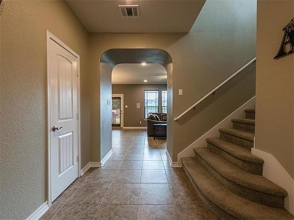 The entry invites you back to the open living and kitchen areas.