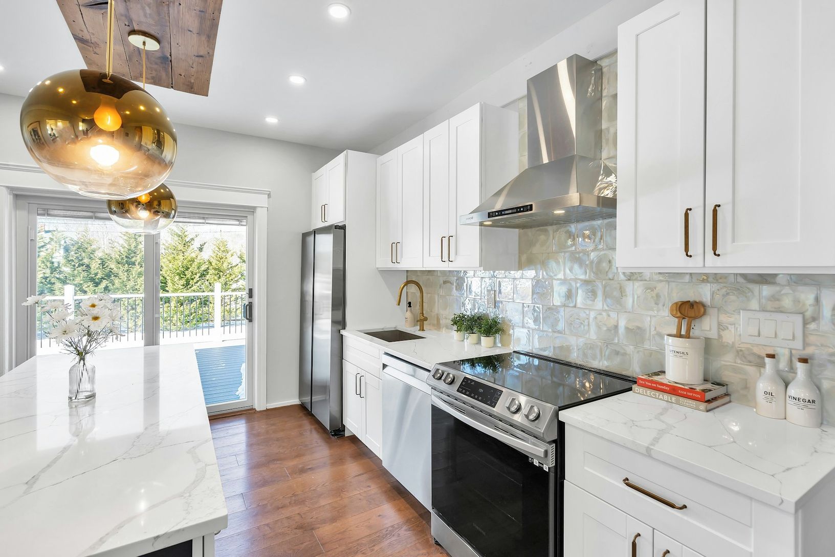  Flooded with light, bright and white chef kitchen with upscale tile backsplash and stainless steel e