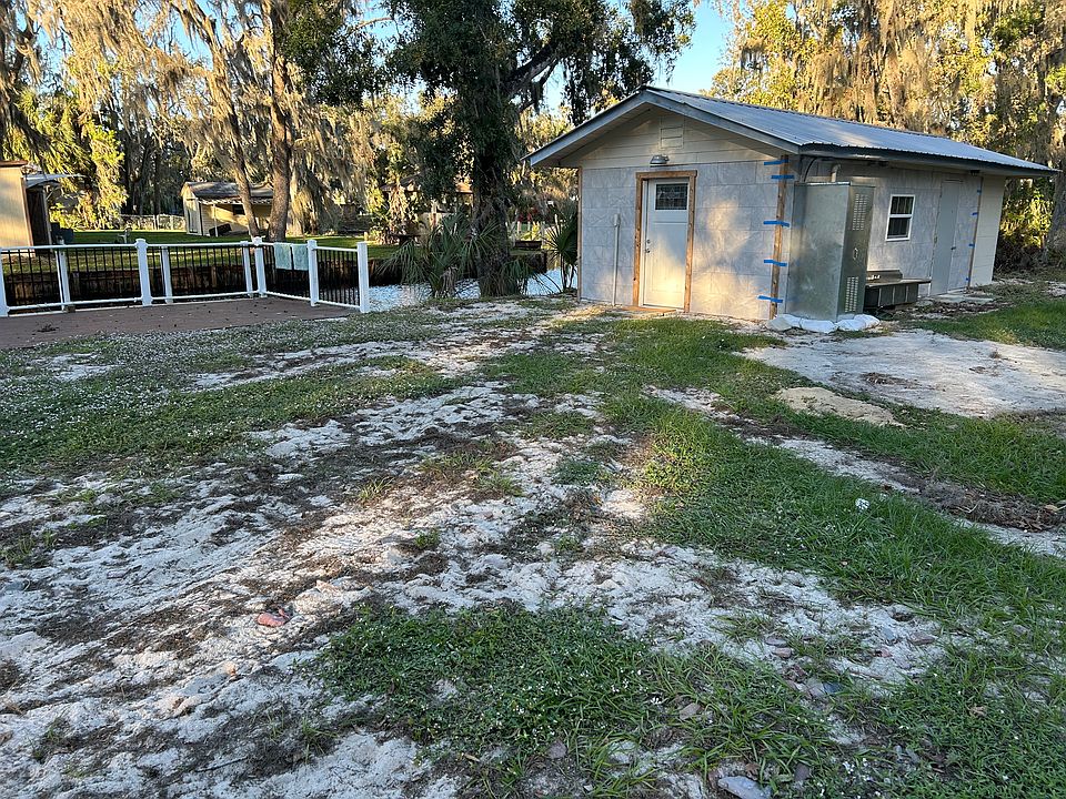 Front of CinderBlock studio next to private deck/dock canal which connects to Walk in Water Lake