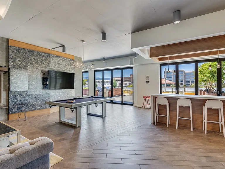 Resident lounge with billiards and views onto the rooftop lounge area