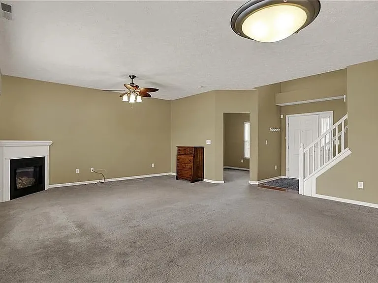 The living room carpet floor has been replaced to light grey hardwood.