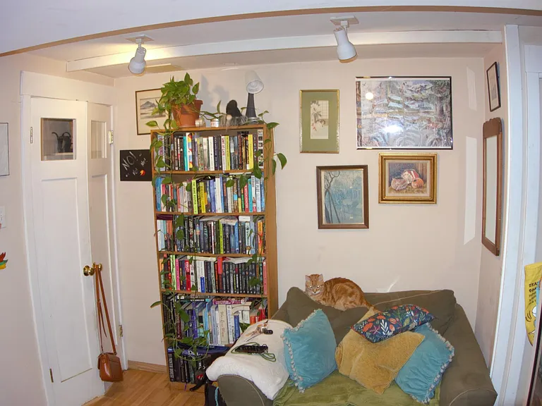Living area has room for small couch plus a shelf
Outside door to your left and kitchen to the right