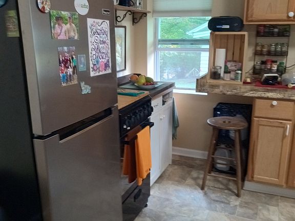 Refrigerator and stove area of kitchen.