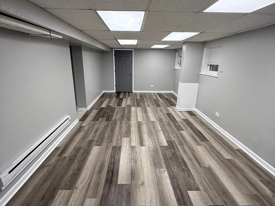 Living Room/Common Space - Back door leading to common Laundry Room and Exit of Building Common Area