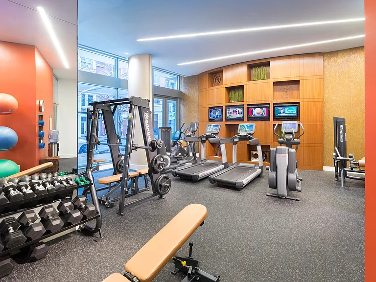 Fully-equipped fitness room with Pelotons