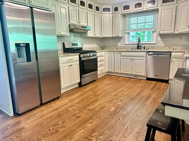 Upstairs full kitchen with stainless steal appliances.