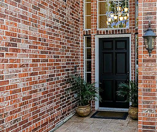 High ceilings and windows are offset by the warmth of the brick exterior.