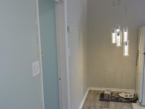 Cozy dining area off kitchen and living room. Stylish and functional overhead lighting included.