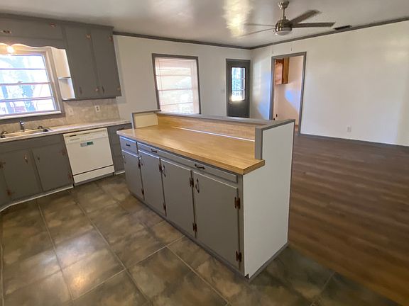 looking from carport entry. Center island kitchen / dinning or sitting area. outside door to porch.