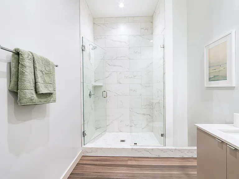 Luxuriate in frameless glass showers with stunning floor-to-ceiling tile surrounds.