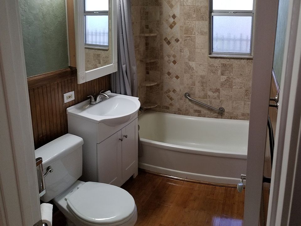 Bathroom with custom tile and large bathtub.