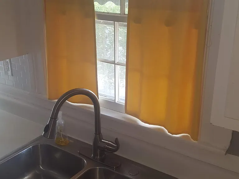 Sink has been updated with a modern pull down single handle faucet.