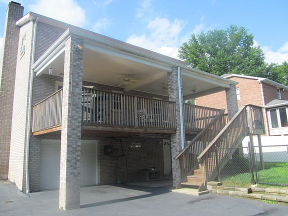 Back of house with covered deck