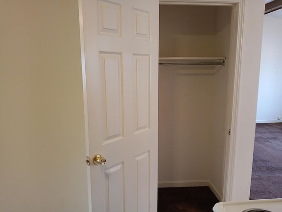 Guest closet/coat closet next to living room.