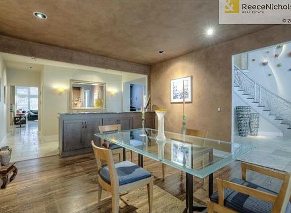 Expansive formal dining with wet bar and granite serving area.