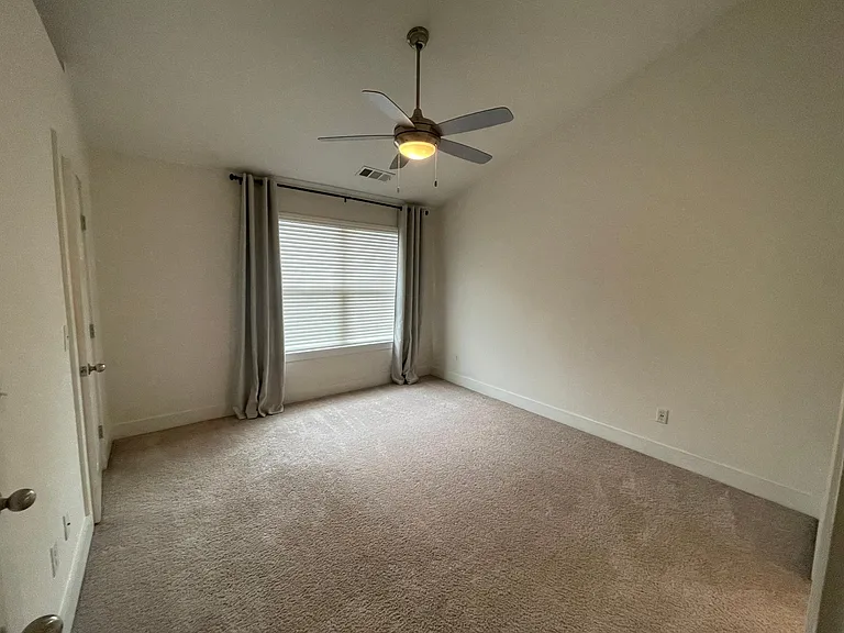 Large master bedroom with ceiling fan, huge window, TWO walk in closets, attached bathroom and VAULTED CEILING