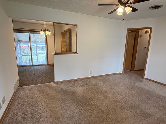 Living room to dining room and hallway. Dining area and kitchen flooring has since been updated. See next photo.
