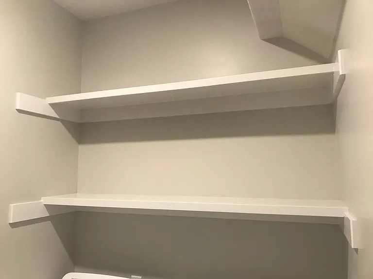 Lower level shelves above washer and dryer.