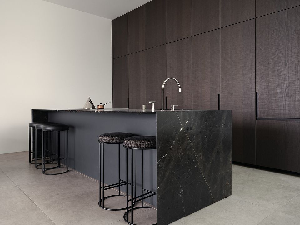 Chef's Kitchen with Striking Marble Island _ Crafted for culinary enthusiasts, this kitchen boasts premium marble countertops, seamless cabinetry, and integrated Miele appliances, ensuring both beauty and functionality.