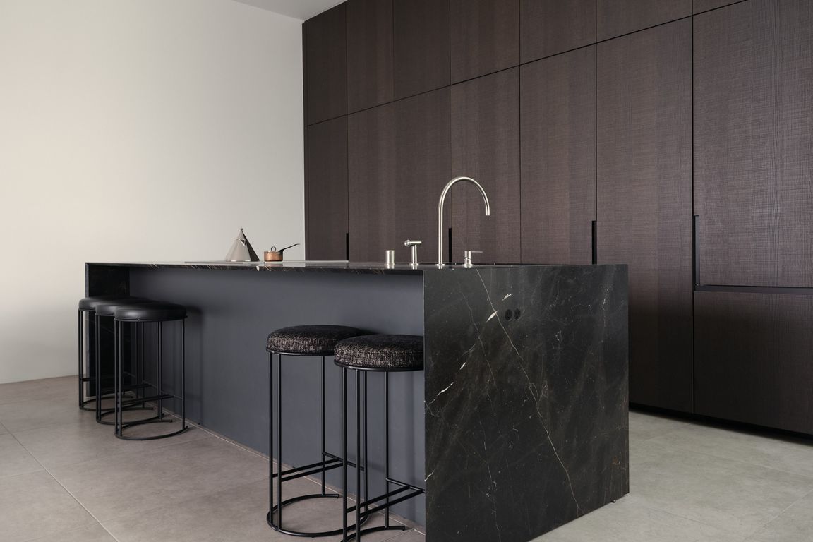 Chef's Kitchen with Striking Marble Island _ Crafted for culinary enthusiasts, this kitchen boasts premium marble countertops, seamless cabinetry, and integrated Miele appliances, ensuring both beauty and functionality.