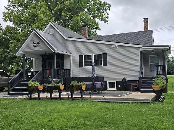 Back view, main entrance is private drive off of quiet alley. Bourbon barrel planters with seasonal herbs and flowers.