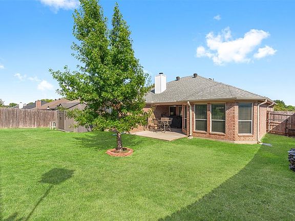Rear view of house with a patio and a yard