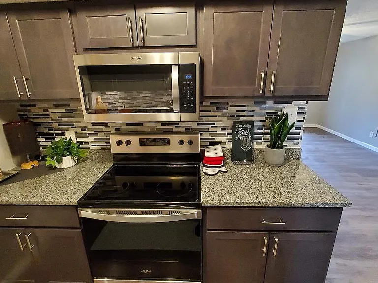 Close up of Cabinets and New Countertops and Glass Tile Backsplash
