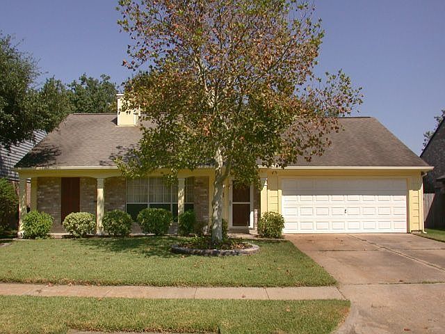 Covered front porch, recent exterior paint and lushly landscaped.