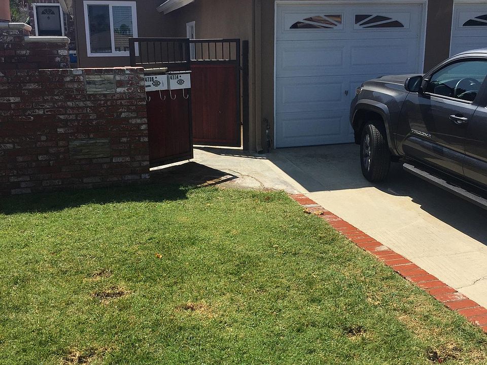 Front yard view towards driveway/patio entry