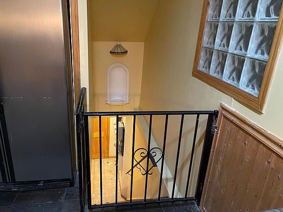 gate to downstairs private laundry room off kitchen