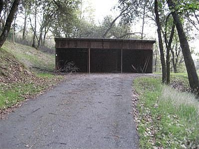 separate entrance/driveway to 3-car workshop with outside RV pad