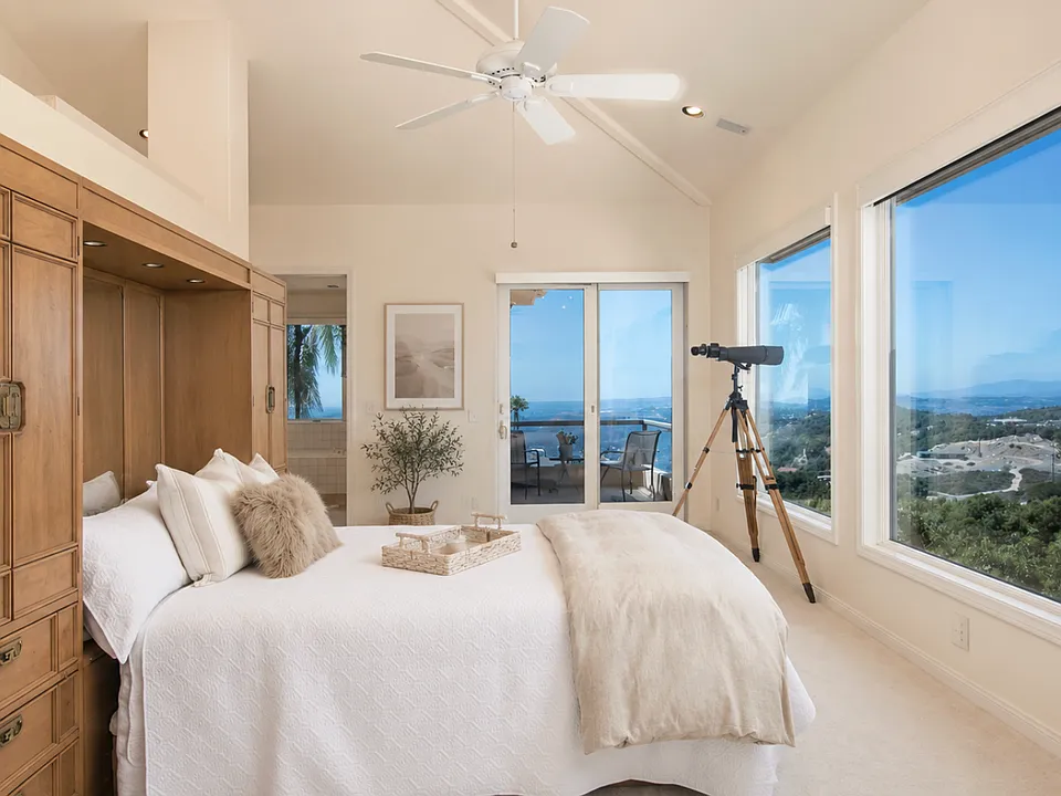 Relax in your primary suite and savor incredible panoramic views spanning from the mountains to the ocean, offering a vantage point that rivals the view from an airplane at over 1,000 feet in the air.