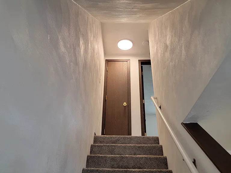 Stair way has new carpet & newly painted.