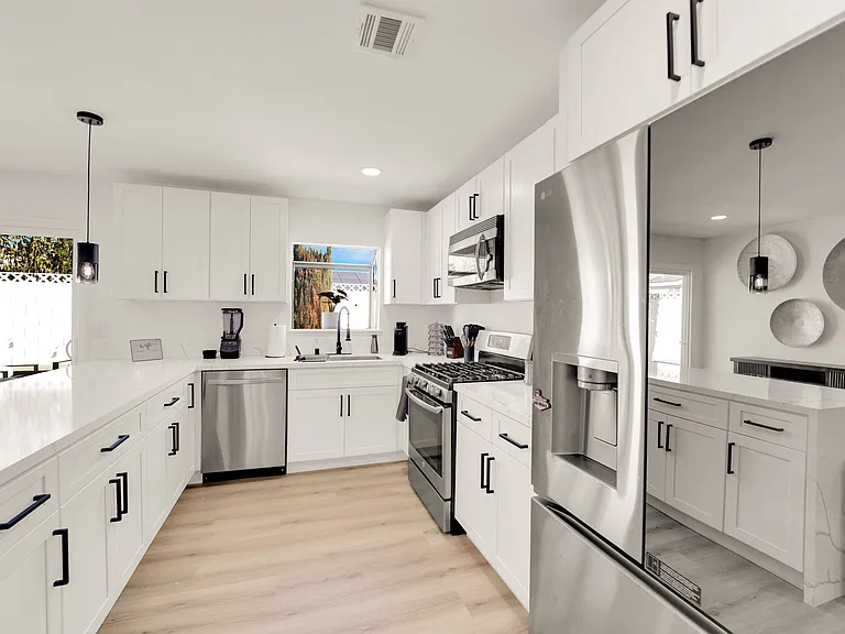 there are now 2 large modern refrigerators in the kitchen.