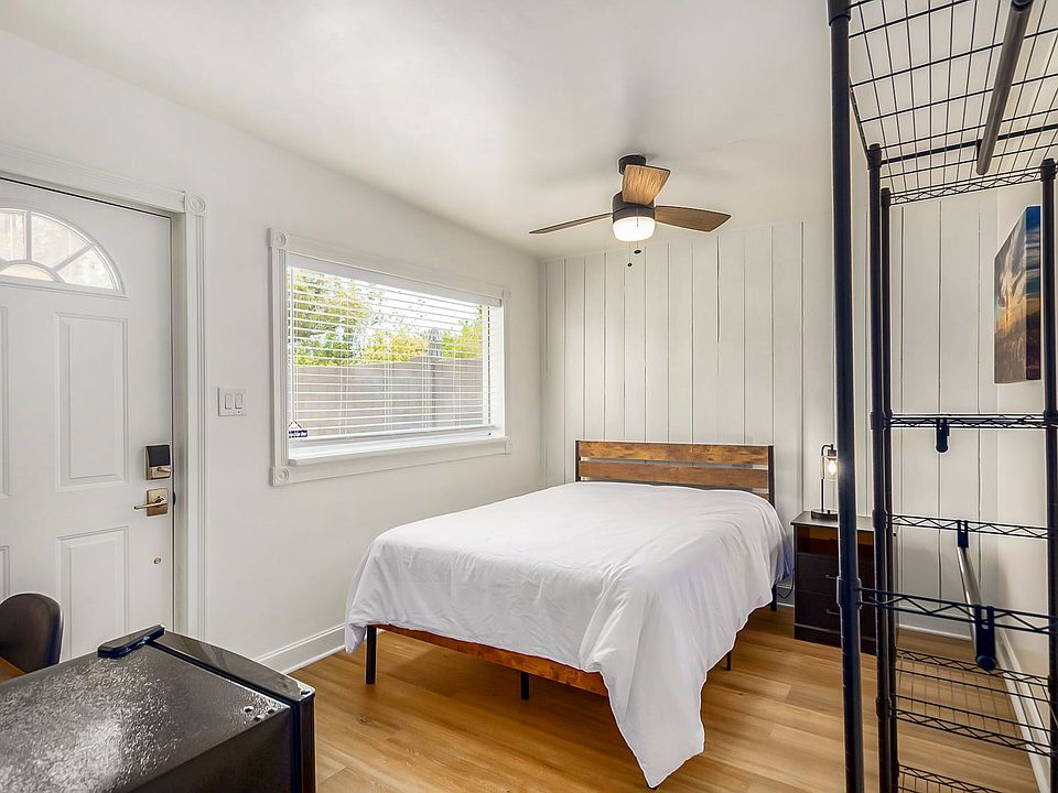 Full size bed with mounted TV