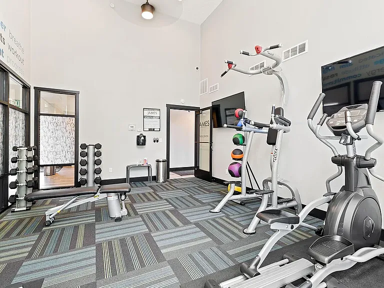 Gym with free weights, treadmill and elliptical machine