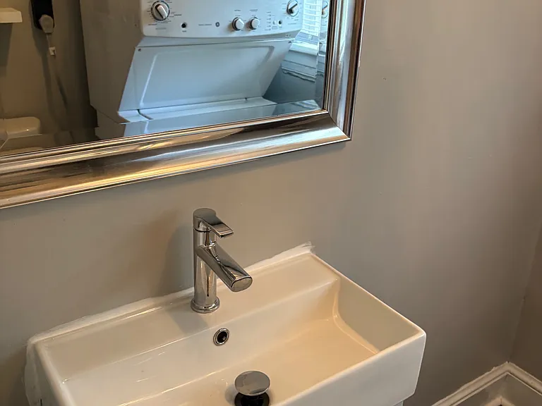 Completely Renovated Half Bath! New Luxury Vinyl Tile, New Vanity, Mirror, Crystal Lighting Fixture, Floating Shelves and NEW Stackable Washer/Dryer!