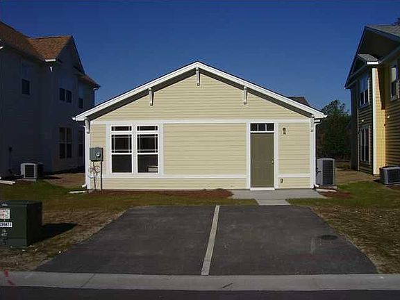 Back of Home with Two Parking Places per Unit